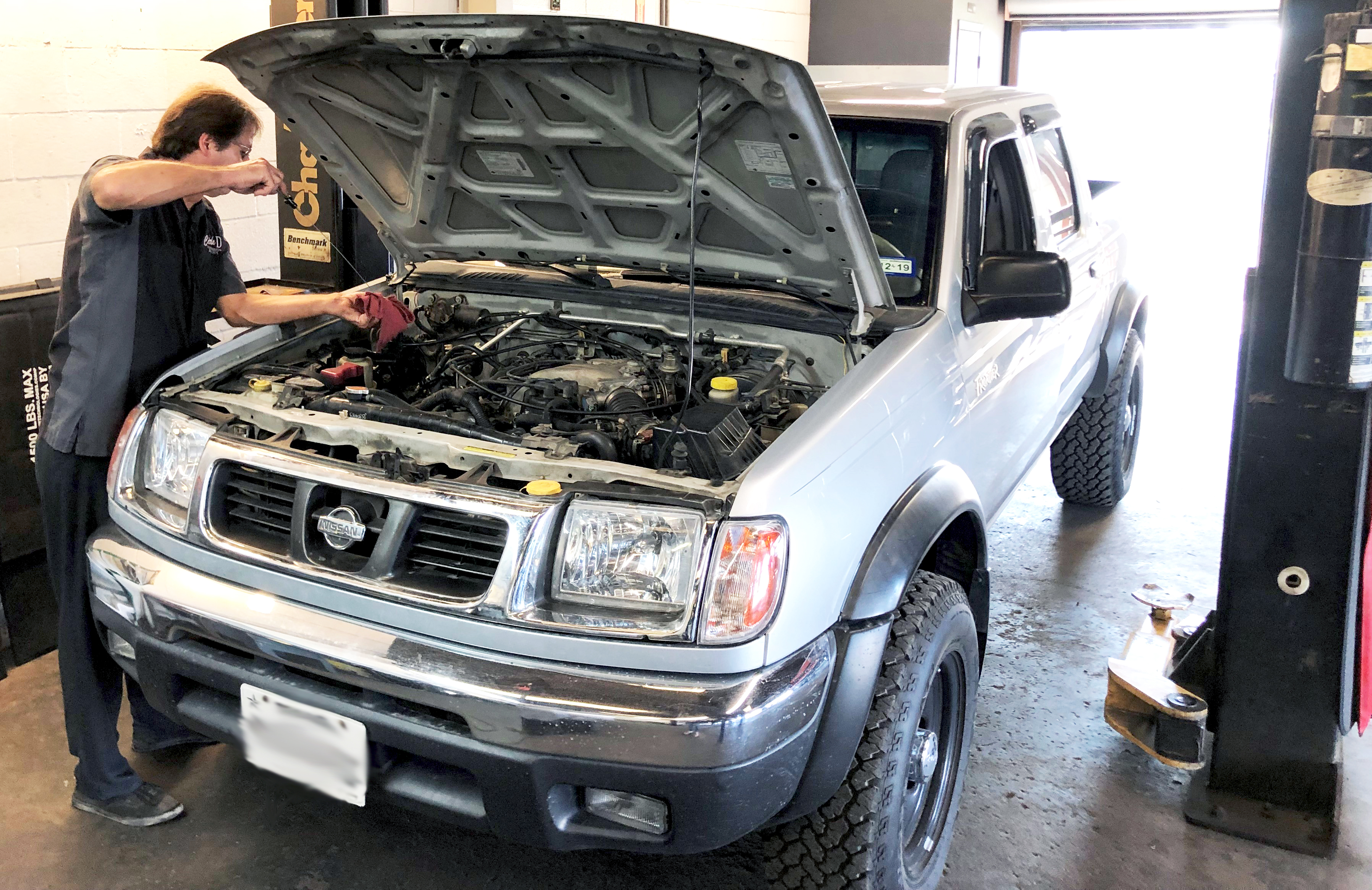 Circle D Transmission Technician Servicing a Nissan Truck