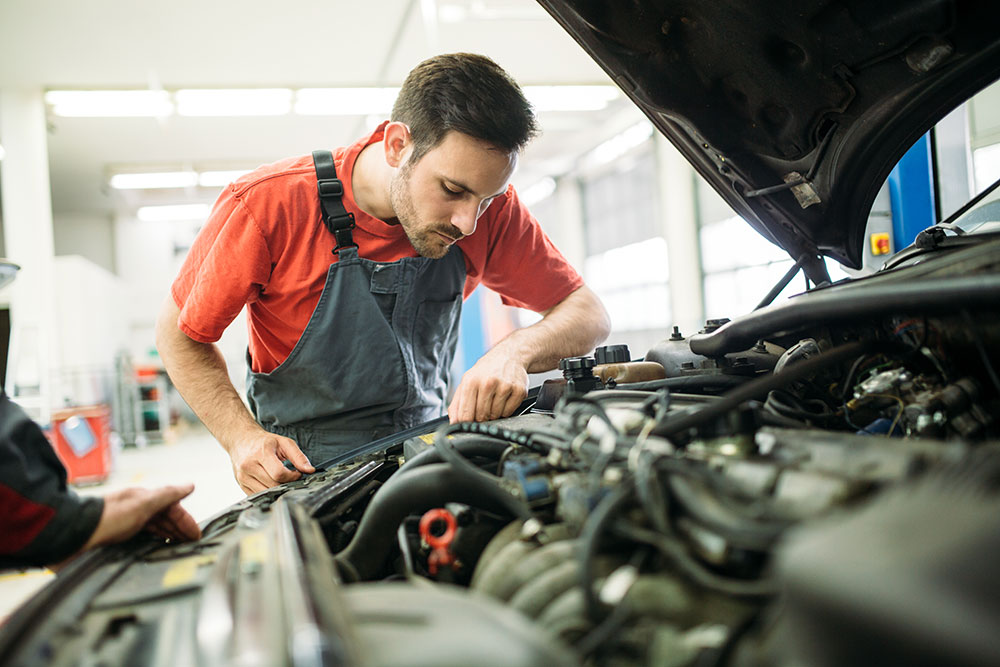 man checking transmission fluid